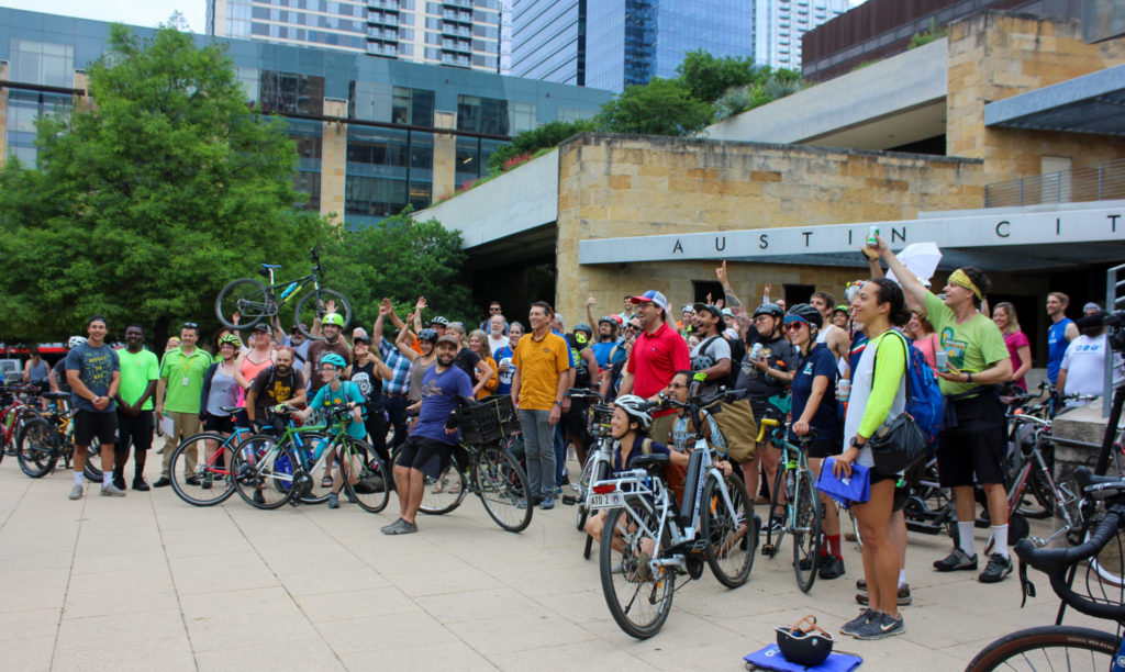Large group of cyclists in front of Austin City All on Bike to Work Day.