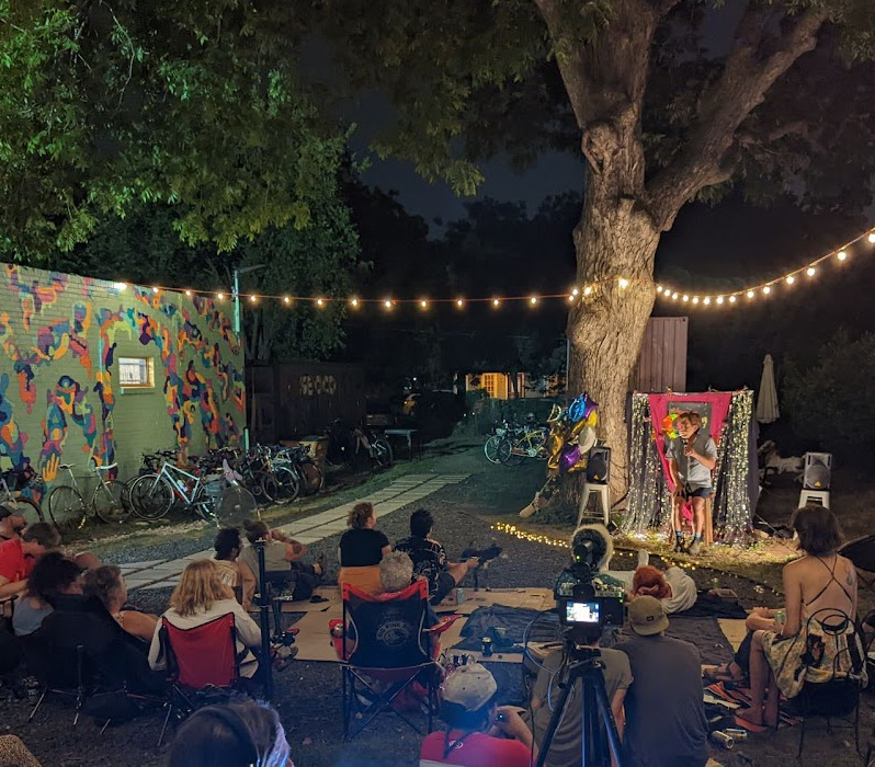 Group of people listening to a story at night.